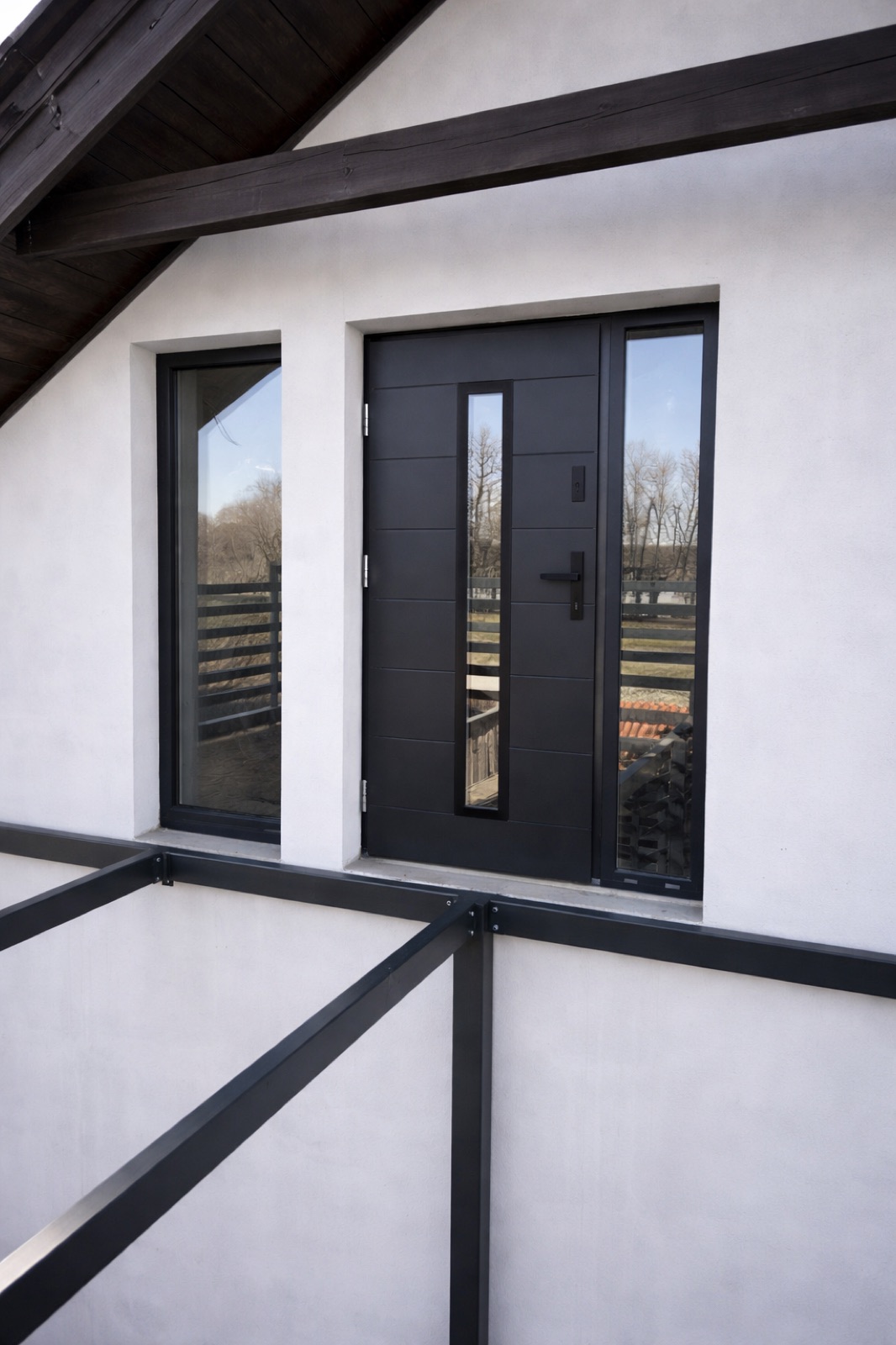Black entrance door flanked by full height glazed sidelights