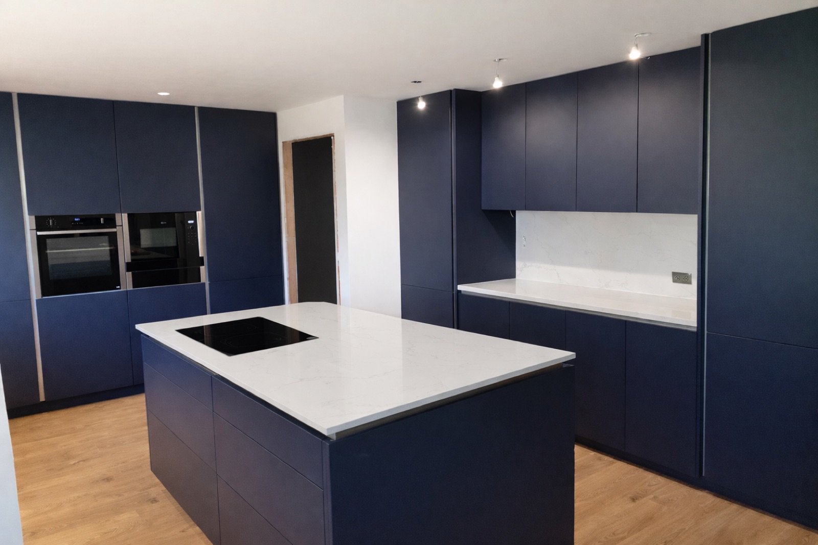 A modern navy kitchen supplied and fitted by LUMA PRIME
